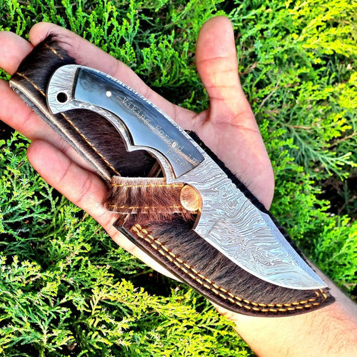 Deer skinning knife with full tang Fire Damascus steel blade and buffalo horn handle.