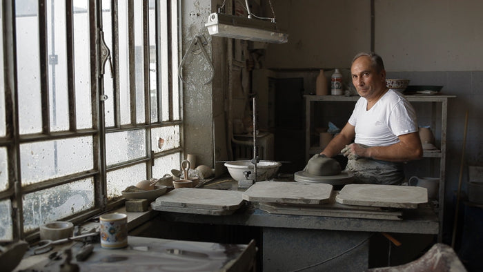 FIMA artisan in Deruta, Italy, hand-painting Antico Deruta dinnerware
