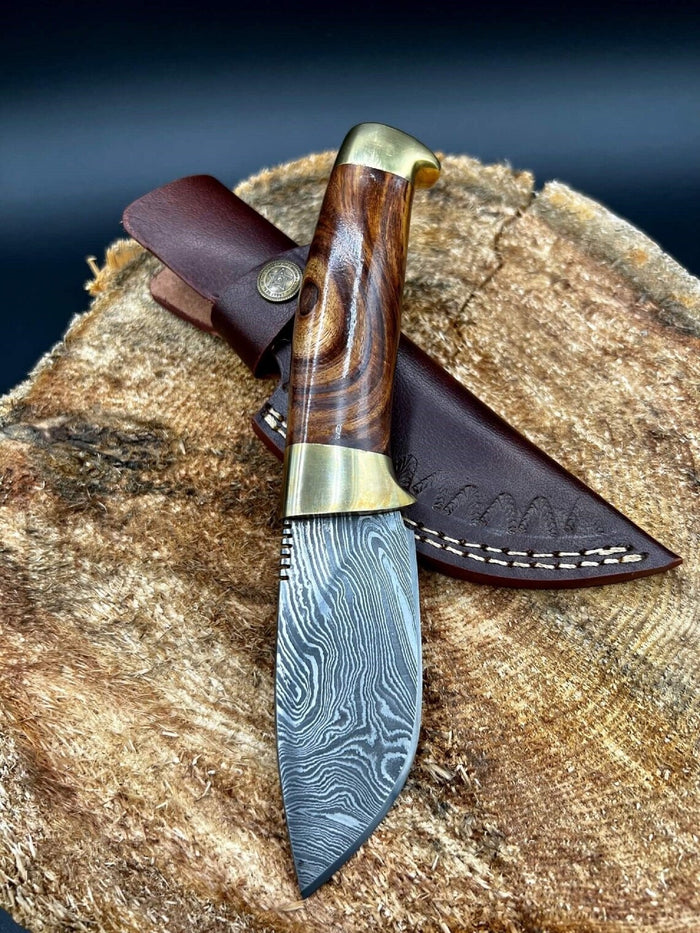 Damascus steel skinning blade with rosewood handle and brass bolsters.