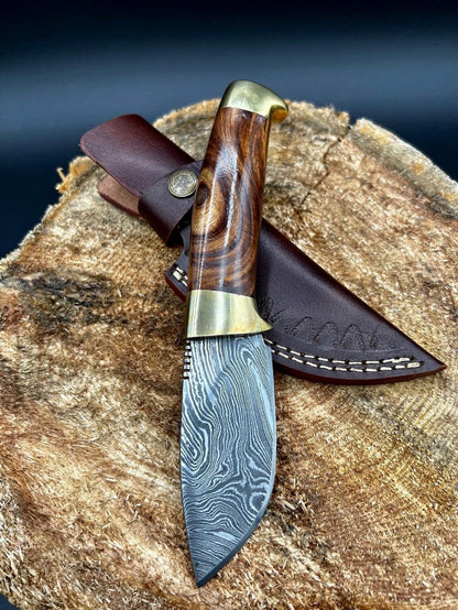 Damascus steel skinning blade with rosewood handle and brass bolsters.